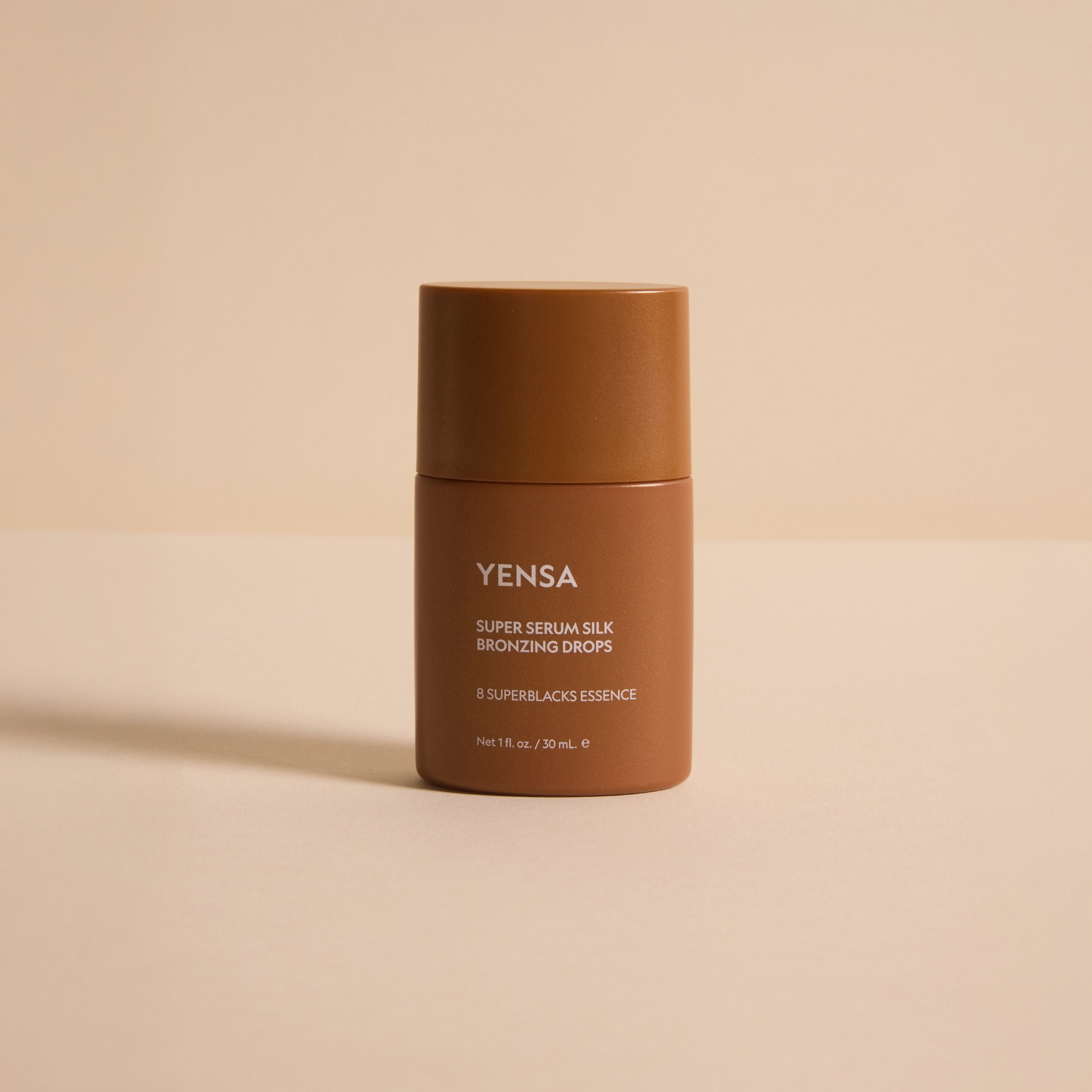 YENSA Super Serum Silk Bronzing Drops in a sleek bottle, showcasing the liquid bronzer with a golden tint and dropper applicator.